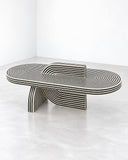 Richard Yasmine AlterAgo Coffee Table featuring an elongated oval top with layered ribbed detailing and distinctive curved supports. Its low-profile silhouette and architectural lines create a sculptural centrepiece for contemporary living spaces.