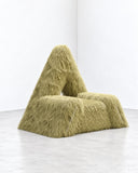 Richard Yasmine Furrybum Green Yellow Fur Armchair featuring a sculptural, angular seat enveloped in shaggy olive-green and yellow-toned fur. Its unconventional silhouette and rich texture create an expressive accent for eclectic contemporary interiors.
