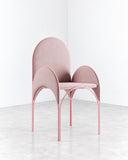 Richard Yasmine Hawa Chair featuring a delicate pink frame, slender legs, and rounded arch-shaped backrests that create a distinctive layered silhouette. Its light, sculptural construction offers a playful interpretation of contemporary seating.
