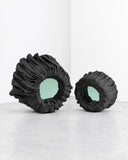 Richard Yasmine Silent Hollows Wall Mirror Set featuring two irregular mirrors framed by sculptural, crumpled black forms in contrasting sizes. Their textured organic outlines create a bold, coordinated wall feature for contemporary spaces.