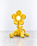Ryan Mercer Extremely Normal Lamp featuring a sculptural yellow base with curling, organic extensions and a flower-like light surround. Its expressive form and bright finish bring an artistic, playful character to contemporary lighting.