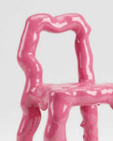Statement designer chair combining sculptural artistry with contemporary design. Crafted to complement luxury living spaces.