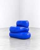 Ryan Mercer Tower Stool featuring stacked, rounded rectangular forms in a vivid cobalt-blue finish. Its layered silhouette and bold monochromatic colour give this sculptural stool a distinctive contemporary character.