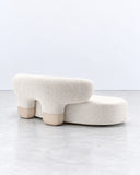 Asawa sofa featuring low, rounded upholstered seating modules in ivory fabric with integrated curved backrests. Its organic silhouette and soft proportions create a relaxed contemporary sofa for residential and hospitality interiors.
