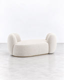 SECOLO Chapter 2 Sofa featuring a low, rounded silhouette with a generously upholstered seat and sculptural curved backrests at both ends. Its compact, organic form brings a contemporary accent to refined residential and hospitality interiors.
