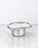 SECOLO X EERA Laghi S coffee table featuring a circular silver-toned tabletop with a raised metallic rim and compact pedestal base. The reflective finish and clean geometry create a refined contemporary accent table.