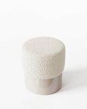 HELVIS stool with a rounded upholstered cushion and contrasting cylindrical base in a smooth finish. Its compact sculptural form works as versatile seating or an accent piece in contemporary interiors.