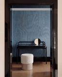 Sculptural HELVIS stool combining a softly rounded upholstered seat with a smooth cylindrical base. The minimalist design balances tactile comfort with contemporary furniture craftsmanship.