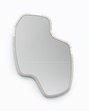 Contemporary LAB L mirror with an elongated organic silhouette and slim light-toned frame. Its fluid asymmetrical geometry creates a distinctive decorative focal point for modern interiors.
