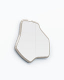 LAB M wall mirror with a compact freeform silhouette, softly angled contours, and slim light-toned frame. Its sculptural geometry creates a refined contemporary accent for residential and hospitality interiors.