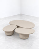 SECOLO Laghi Coffee Table featuring an organic arrangement of rounded tabletops and substantial cylindrical bases in a warm neutral finish. Its layered, asymmetrical silhouette adds a soft sculptural presence to contemporary interiors.