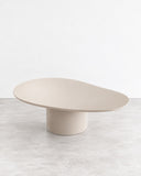 SECOLO Laghi I Dining Table with a softly oval tabletop and a substantial cylindrical pedestal in a warm beige finish. Its minimal, rounded silhouette offers understated elegance for contemporary dining rooms and hospitality interiors.