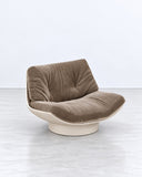 SECOLO Lalea Lounge Chair featuring plush taupe upholstery with elegant gathered detailing, a sculptural ivory outer shell, and a rounded pedestal base. Its enveloping silhouette and contrasting finishes bring refined comfort to contemporary luxury residential and hospitality interiors.