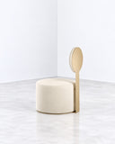 Pop lounge chair featuring a compact upholstered seat and a tall, oval backrest on a slim vertical support. Its playful proportions and contrasting forms create a distinctive contemporary seating design.