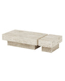 Sculptural THERRA coffee table crafted from light travertine with a rectangular top and asymmetrical block supports. The natural stone texture and monolithic construction emphasize its architectural character.