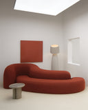 TRACE ISLAND sculptural sofa featuring interconnected curved upholstered modules and a low-profile silhouette. The fluid configuration combines generous seating with expressive contemporary design.