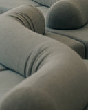 Close-up of the TRACE MODULAR sofa highlighting its plush upholstery, curved modules, and softly defined seams. The tactile construction emphasizes the comfort and sculptural character of the modular seating system.