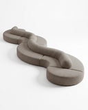 TRACE MODULAR sectional sofa featuring rounded upholstered modules joined into a flowing sculptural composition. Its flexible configuration creates a distinctive seating landscape for contemporary interiors.