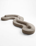 Contemporary TRACE MODULAR sofa featuring low-profile curved modules arranged into a fluid sculptural composition. Its generous upholstery and modular construction offer versatile seating for refined interiors.