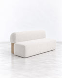 SECOLO Yemeni Family Sofa featuring a clean, low-profile silhouette with softly textured ivory upholstery and a contrasting warm-toned side detail. Its generous proportions and geometric form suit contemporary luxury residential and hospitality interiors.