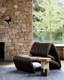 Designer leather armchair showcasing flowing curves and meticulous handcrafted detailing. Crafted as a sophisticated accent chair for luxury interiors.