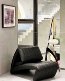 Sculptural lounge chair upholstered in premium leather with a contemporary organic silhouette. Designed to provide exceptional comfort and architectural elegance.