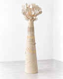 Sandrine Herlin Baobab Blanco Lighting featuring a tall, tapered ivory form with a textured surface, delicate perforations, and branching sculptural elements topped with translucent details. Its organic, tree-inspired silhouette creates an artistic lighting statement for refined contemporary interiors.