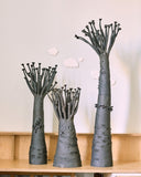 Collection of BAO B104 sculptural vessels featuring tapered forms and branching organic elements in varied proportions. Their textured surfaces and handcrafted silhouettes create a striking contemporary display.