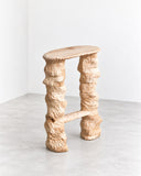 Tellurico 2LEGS Bar Stool featuring two sculptural, organically textured legs connected by a horizontal footrest beneath a slim rectangular seat. Its irregular, tactile finish and distinctive construction give this contemporary bar stool an expressive handcrafted appearance.