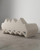 Lighting Sofa showcasing sculptural angular upholstery and a geometric openwork base. A contemporary designer sofa designed for luxury residential and hospitality spaces.