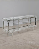 Looking Glass Cabinet combining a sculptural reflective metal frame with clear glass doors and shelves. A distinctive designer cabinet for contemporary residential and hospitality spaces.