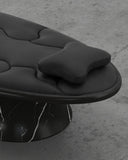 Close-up of the Troy Smith Off Balance Daybed showcasing its sculptural black upholstery and veined marble base. Designed as a distinctive lounge piece for sophisticated interiors.