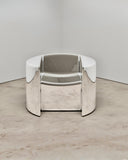 Troy Smith Pill Chair featuring a sculptural curved form with polished reflective metal surfaces. A contemporary designer chair for sophisticated luxury interiors.