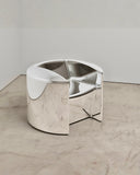 Sculptural Pill Chair with curved metal construction and a polished reflective finish. A statement designer chair for luxury residential and hospitality interiors.