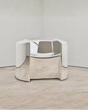 Troy Smith Pill Chair showcasing rounded metal panels and a sculptural contemporary profile. Designed to bring architectural character to sophisticated interiors.