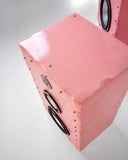 Contemporary Brutalist speaker showcasing a textured pink enclosure with integrated multi-driver audio components. The monolithic form highlights handcrafted detailing and sculptural craftsmanship.