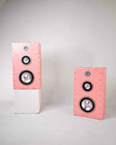 Sculptural pair of pink Brutalist speakers featuring textured handcrafted cabinets and geometric architectural forms. Designed as functional statement pieces for luxury residential and hospitality interiors.