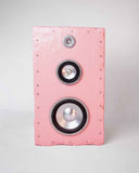Handcrafted pink speaker with a textured Brutalist cabinet and exposed multi-driver configuration. The sculptural design merges premium acoustic performance with collectible contemporary aesthetics.