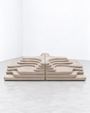de Sede Terrazza modular sofa in a light neutral finish, featuring a low platform-like profile with repeated raised, cushioned sections. Its architectural arrangement and sculptural upholstery create a distinctive contemporary lounge setting.
