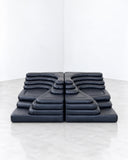 de Sede Terrazza modular sofa in dark navy upholstery, featuring a low, geometric composition with repeated padded sections and a sculptural, platform-style form. Its bold colour and structured arrangement make it a distinctive centrepiece for contemporary residential and hospitality spaces.
