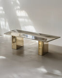 Modern coffee table with gold legs on a light floor and white wall background