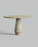 Round marble table with a cylindrical base on a gray background