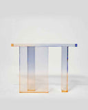 Modern gradient console table casting colorful shadows in a minimalist interior